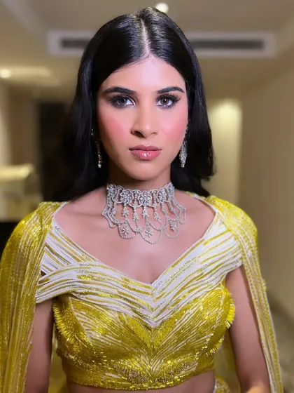 A more intense, direct look, showing how the soft smokey eye defines and enhances her features for the sangeet night.