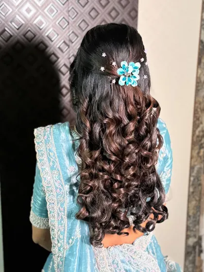 A detailed shot of the back of her hair, showing the beautiful blue floral accessory that perfectly matches her outfit.