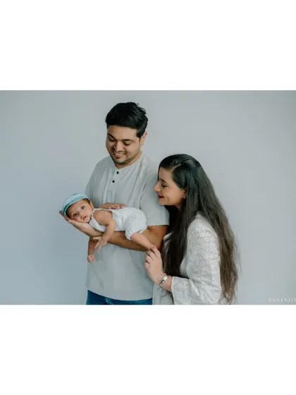 A slightly different angle showing the parents' loving gaze upon their new baby. It’s a quiet moment filled with immense love.