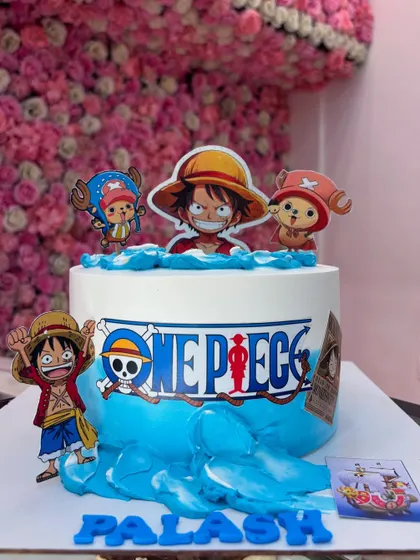 For the anime fans, here is a 'One Piece' themed cake. It features popular characters and the series logo, all created with edible prints and fondant for a clean, vibrant look.