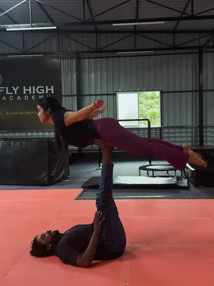 The "bird" pose in acro yoga is a foundational move that builds trust and stability between partners.