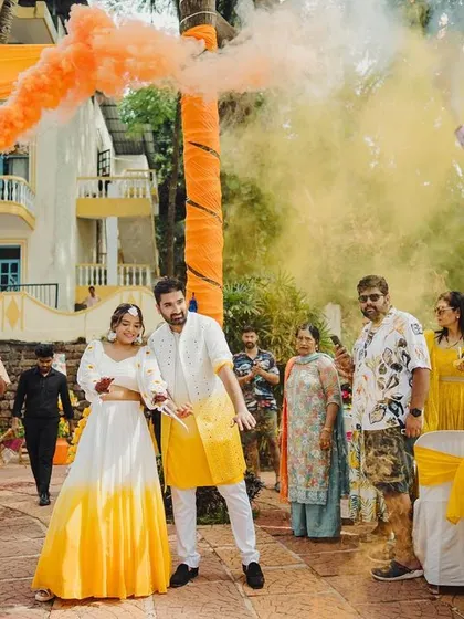 Making an entrance with a bang! The couple's entry was a high-energy affair with colorful smoke bombs and the infectious beats of dhol players, setting the tone for a fun-filled Haldi.