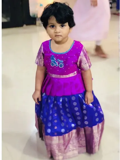 This little one looks so sweet in her custom outfit. The peplum blouse is a comfortable and stylish alternative to a standard blouse, giving the traditional Pattu Pavadai a fresh look.