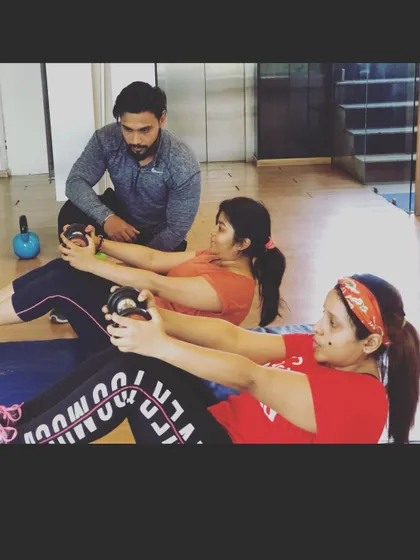 I provide hands-on coaching for small groups as well as individuals. Here, I am supervising an ab workout, ensuring everyone maintains correct form for an effective core session.