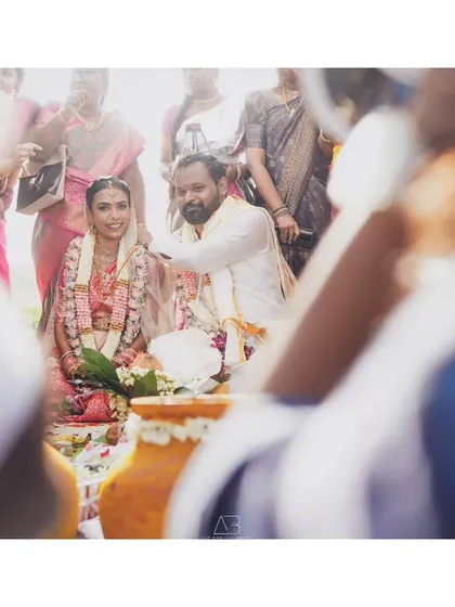 A candid shot from a different perspective, capturing the wedding ceremony through the crowd. This angle makes you feel like you are right there, witnessing the moment unfold.