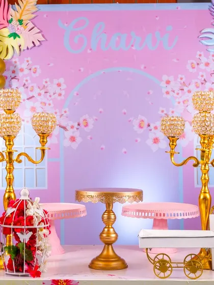 The elegant details of the flamingo party, with crystal candelabras and gold cake stands against a soft, cherry-blossom-like backdrop. This theme is perfect for a sophisticated celebration.