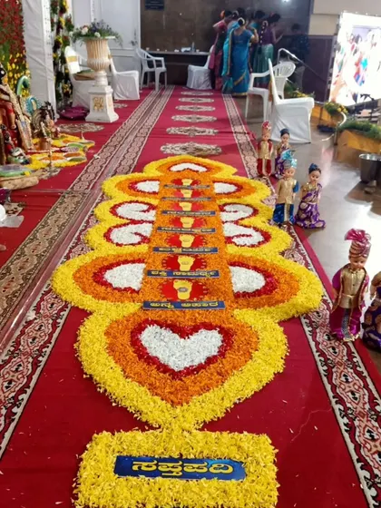 A traditional floral rangoli for a Kashi Yatre ceremony. The intricate design, made with marigold and rose petals, honors the cultural significance of the ritual.