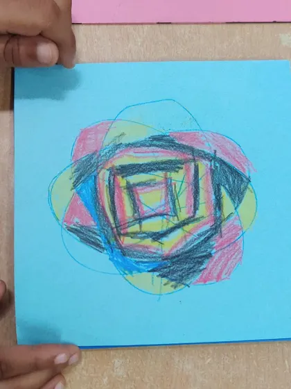 Using metal insets for drawing helps children refine the hand movements needed for writing. This piece shows a child's creative exploration with colors and overlapping shapes, demonstrating the freedom of expression we encourage.
