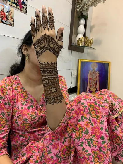A client showing off her beautiful elephant motif mehndi at home. It's a pleasure to bring my art to your personal space, making your celebrations convenient and memorable.