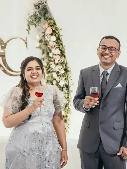 A toast to the happy couple. The simple and elegant backdrop with a floral arch and their monogram allows the focus to remain on their joyful celebration.