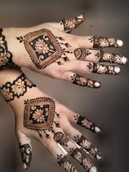 A modern take on a traditional design, with a central lotus motif and spaced-out finger details.