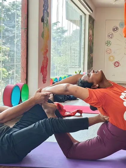 Partner stretches like this one help in achieving a deeper release. This assisted backbend and hip opener builds trust and enhances flexibility.