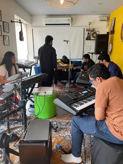 A full view of our music workshop in session. With keyboards, guitars, and drums, we have all the gear needed for a large group to learn and jam together.