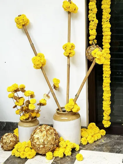 Another view of the modern-traditional marigold arrangement, showing how we use bamboo sticks to create height and structure, offering a contemporary take on classic floral decor.