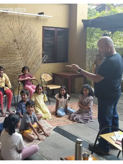 A storyteller engages with a group of children in our outdoor courtyard space. We use all parts of our venue to create magical experiences.