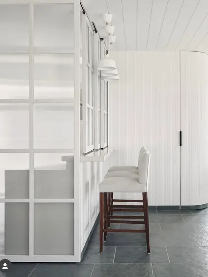 From the archives, a project celebrating Indian materials. Here, we used beautiful Kota stone for the flooring, paired with a minimalist white bar and curved architectural details.