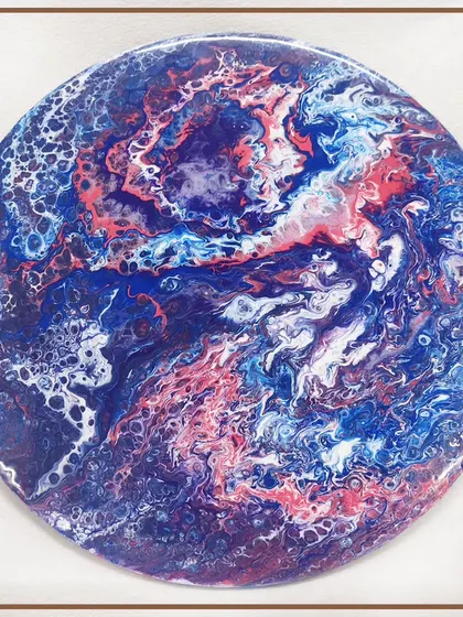 A circular resin art piece resembling a planet or a marble. The possibilities with resin are endless, from home decor to personal accessories.