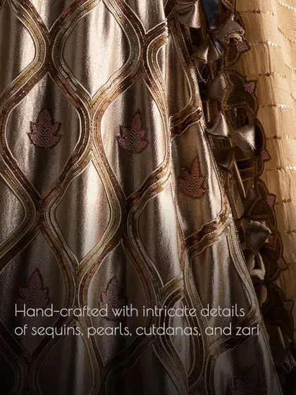 A close-up of the hand-crafted details on a bridal lehenga, featuring a combination of sequins, pearls, cutdanas, and zari work that creates a rich, textured look.