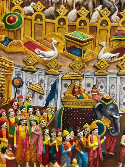 Detail of the procession in the Samavasarana mural, with dozens of individually sculpted and painted figures, elephants, and swans.