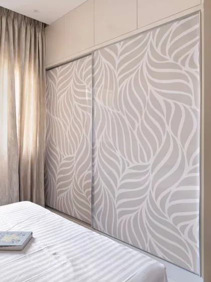 This daughter's room in the 'Muditā' project features a sliding wardrobe with a custom digital print laminate, adding a personal and artistic touch to the space.