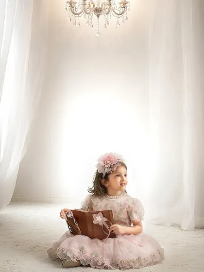 A dreamy and elegant portrait. This simple, high-key setup with a beautiful chandelier creates a timeless and classic princess look.