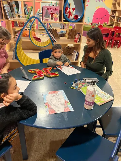 A quiet, focused moment writing letters to Santa Claus. This is a cherished Christmas tradition at The Reading Room that encourages writing and imagination.