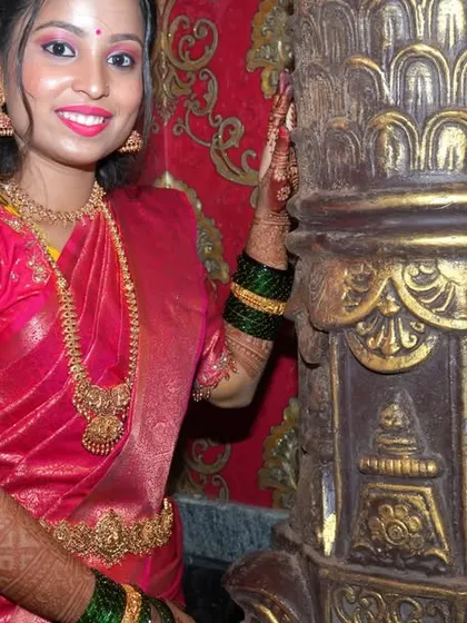 A posed portrait next to an ornate pillar, adding a touch of traditional architecture to the photograph. I often use the venue's features to create more interesting compositions.