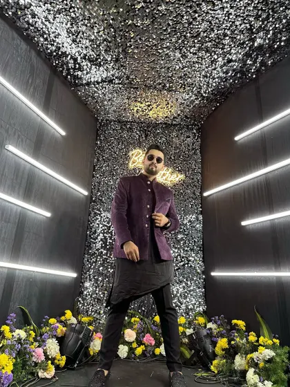 A wide-angle shot showing the full effect of the glamorous photo booth and my stylish outfit.
