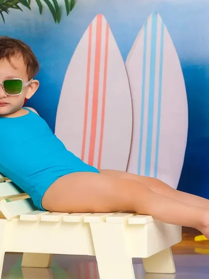 The epitome of cool. This little one is lounging like a pro in her sunglasses, ready for a day of sun and fun.
