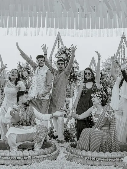 A classic black and white group photo from the Haldi ceremony, capturing the joy of the couple and their friends in a timeless format.