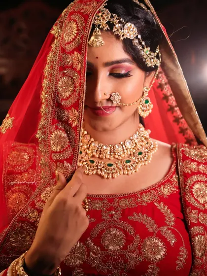 A series of portraits showcasing a model in a heavily embroidered red bridal lehenga. I focused on capturing the intricate details of the outfit and the flawless bridal makeup, presenting a look of regal elegance.