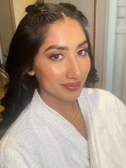 A getting-ready shot in a comfy robe. This is where we plan the look and start creating the magic.