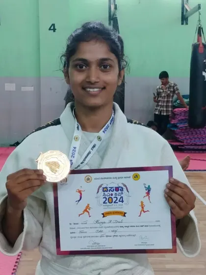 Our Judo coach Ramya with her gold medal from the Mysore Dasara 2024 games. Our coaches don't just teach; they compete and win at a high level.