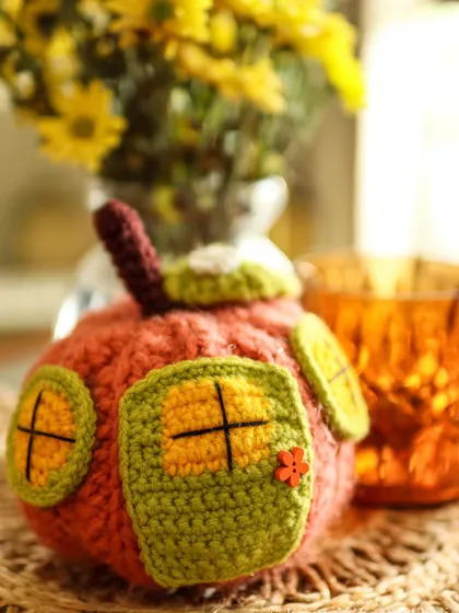 A close-up of the whimsical Pumpkin House, with its tiny door and windows.