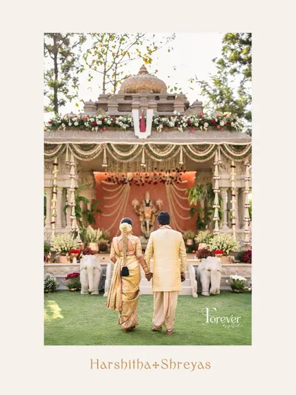 A beautiful shot of the bride and groom walking towards the mandap, a symbol of starting their new life together.