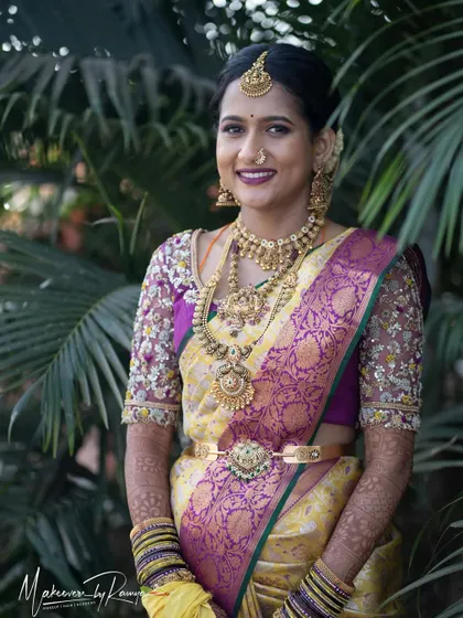 Jagruthi looking stunning for her wedding ceremony. The yellow and purple Kanjeevaram saree is a vibrant and traditional choice, paired with a bold lip and elegant gold jewelry.
