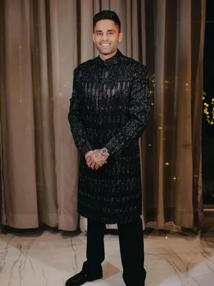 A full-length shot of Suryakumar's sparkling Manish Malhotra look. It’s festive, modern, and full of star power.