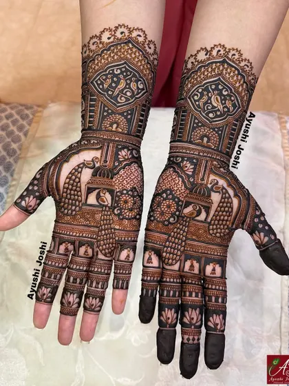 The front view of this engagement design, featuring symmetrical patterns of peacocks and parrots within traditional jharokha (window) frames.