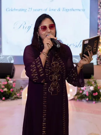 On stage, ready to host a 25th anniversary party. My job is to narrate the beautiful journey of the couple and celebrate it with all their loved ones.