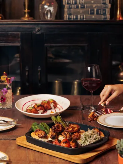 An ode to hands and food. A table set for two, with wine and our sizzling Turkish platters, ready for a conversation with food.