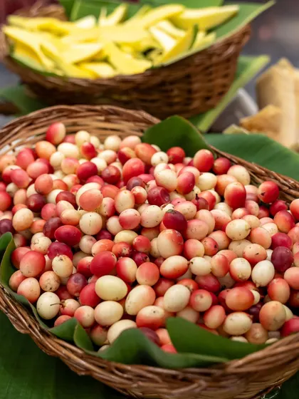 Baskets overflowing with colourful karonda berries and sliced raw mangoes. This display is not just food, but a colourful and interactive experience for everyone.