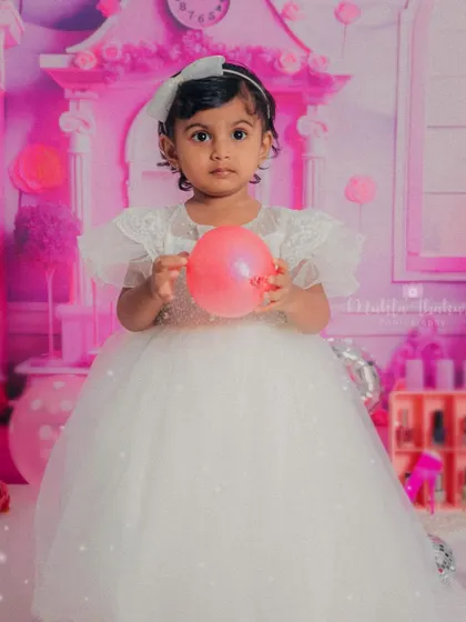 Posing like a real doll in her beautiful white dress. This Barbie-themed shoot was a dream come true for her second birthday.