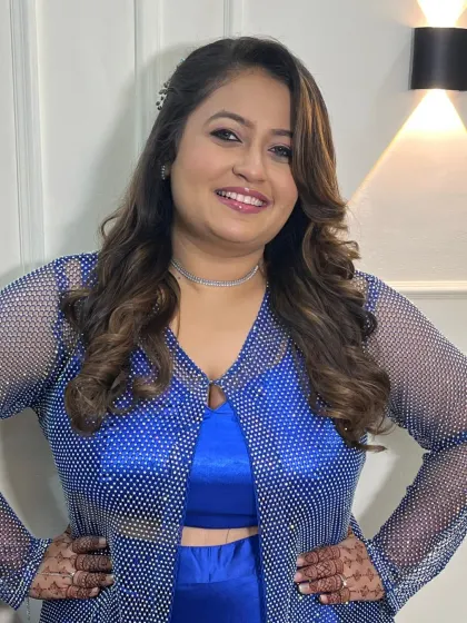 A full-length shot showing the complete party-ready look. The makeup is designed to complement the sparkling outfit.