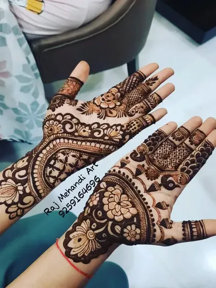 A lovely party mehndi design with a mix of styles. One hand features a floral and paisley pattern, while the other has a more geometric look, showing the versatility of my art.