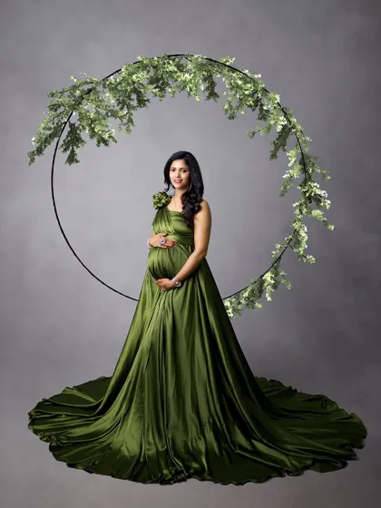 A simple, elegant portrait in an olive green satin gown. The greenery hoop provides a beautiful, natural frame that complements the color of the dress perfectly.