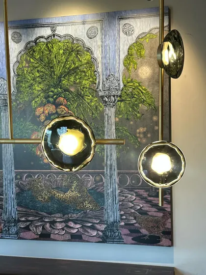A close-up of the Ceto chandelier, showing the detail of the mouth-blown glass shades with their unique, rippled edges.