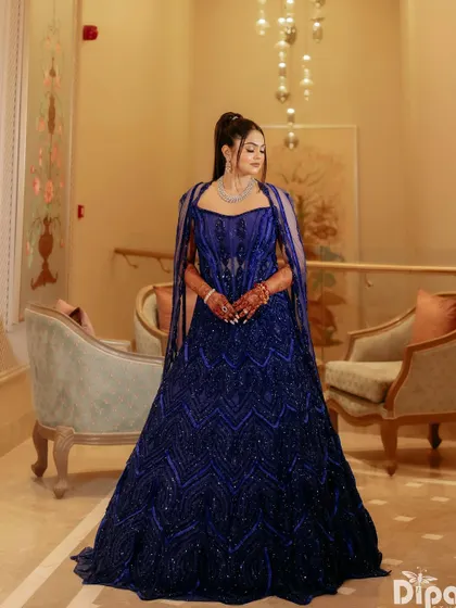 A client looking absolutely splendid in an active blue, fully embellished corset lehenga, a perfect balance of bold, modern, and timeless.