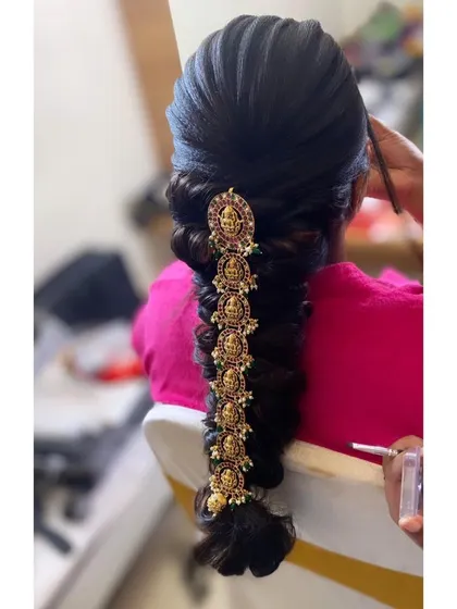 A close-up of a modern take on a traditional braid, showing how I use extensions to create a thick, voluminous base before adding the temple jewellery accents.