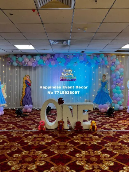 A full, straight-on view of the princess first birthday stage, showcasing the symmetrical arrangement and the beautiful lighting.