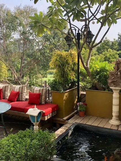 What a pretty setup on a small balcony. It has space for everyone, from fish in the pond to birds, and is perfect for yoga or parties. A happy place attracts happy visitors.